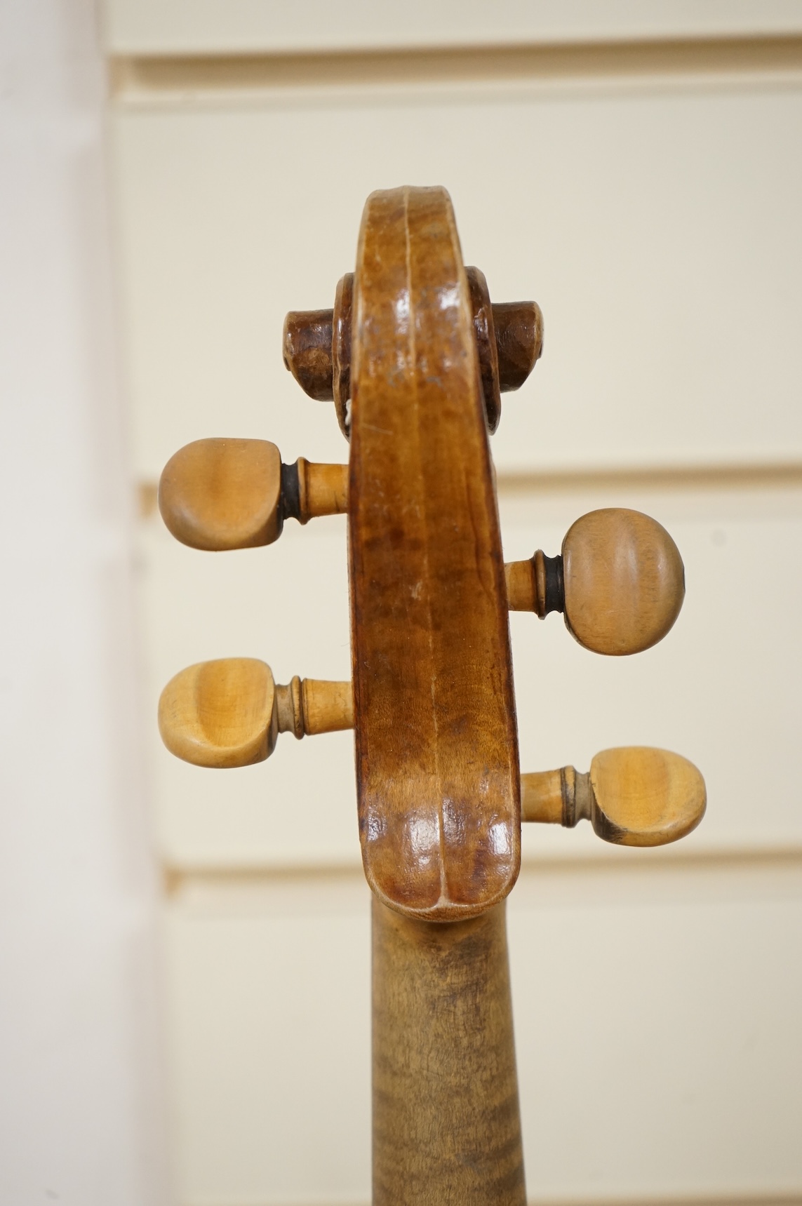 Five cased 20th century violins, including; a German violin, two Czech violins, a three-quarter size violin with a label for Bienfait, and a Romanian quarter size violin, all in cases or the remains of cases.